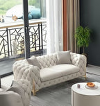 Modern living room with a tufted white sofa, round coffee table, and decorative elements.