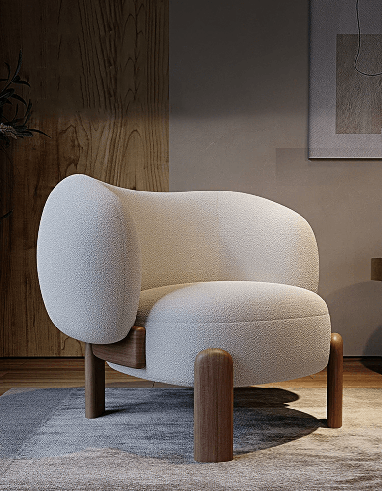 Modern beige armchair with wooden legs in a room setting