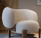 Modern armchair with textured white upholstery and wooden legs in a room setting.