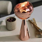 Copper-colored decorative object on a surface with a blurred background