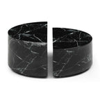 Two black marble cylindrical objects on a white background