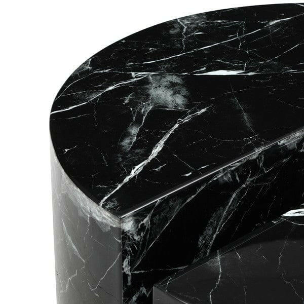 Black marble side table with a curved design on a white background