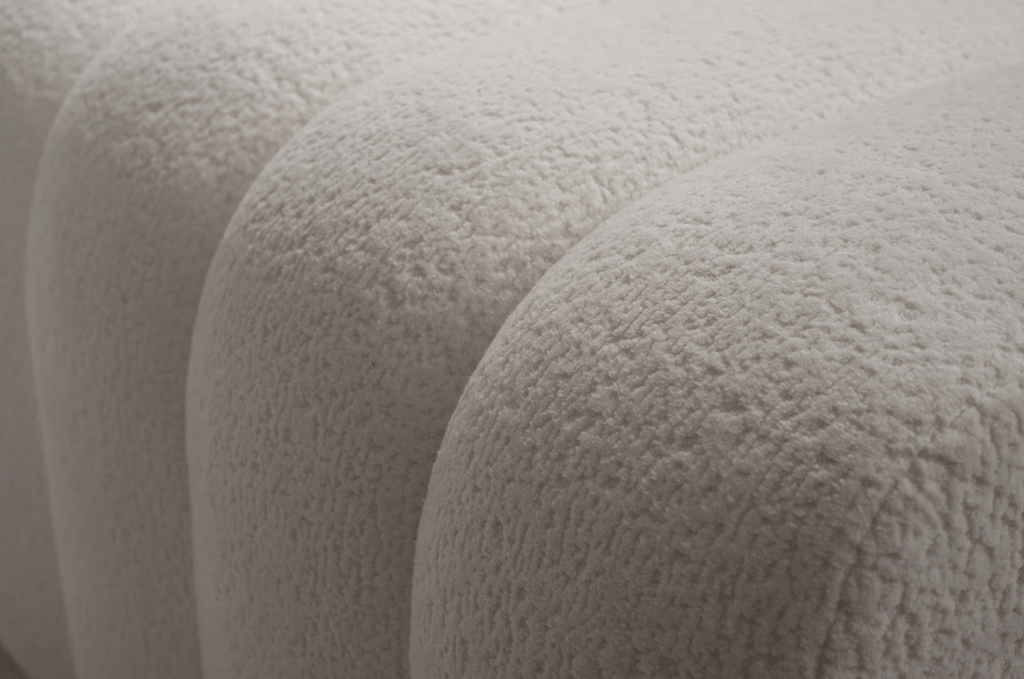 Close-up of textured beige fabric with a soft, plush surface.