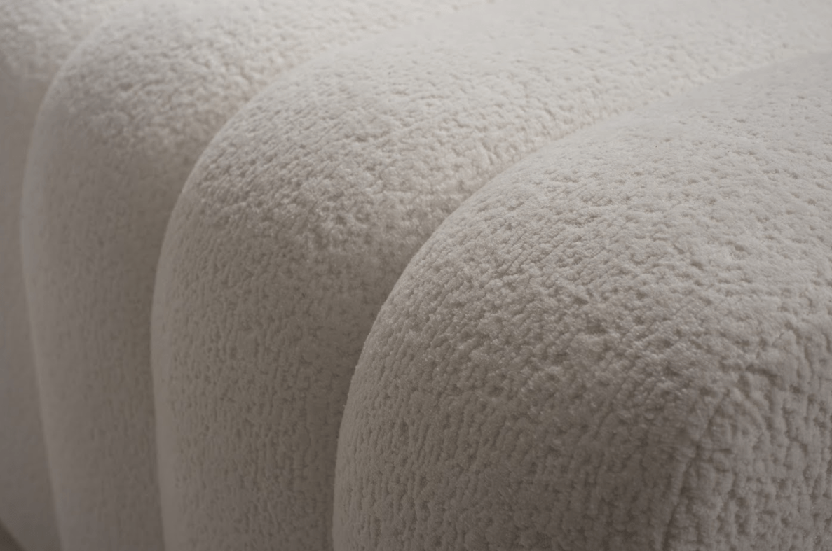 Close-up of textured beige fabric with a soft, plush surface.