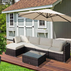 Outdoor patio furniture set with a large umbrella on a wooden deck.