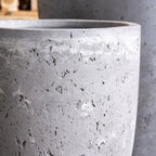 Close-up of a textured gray concrete planter