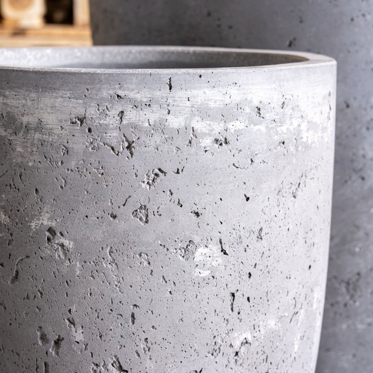 Close-up of a textured gray concrete planter