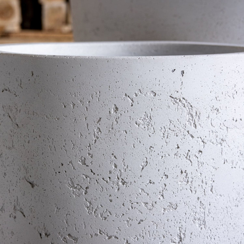 Close-up of a textured gray pot with a blurred background