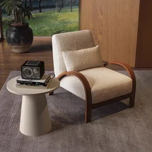 Two modern style armchairs, one with deep blue and brown lines, the other with beige and light brown lines, both with high-quality fabric seats, positioned in a room with a large window and a plant in the background.