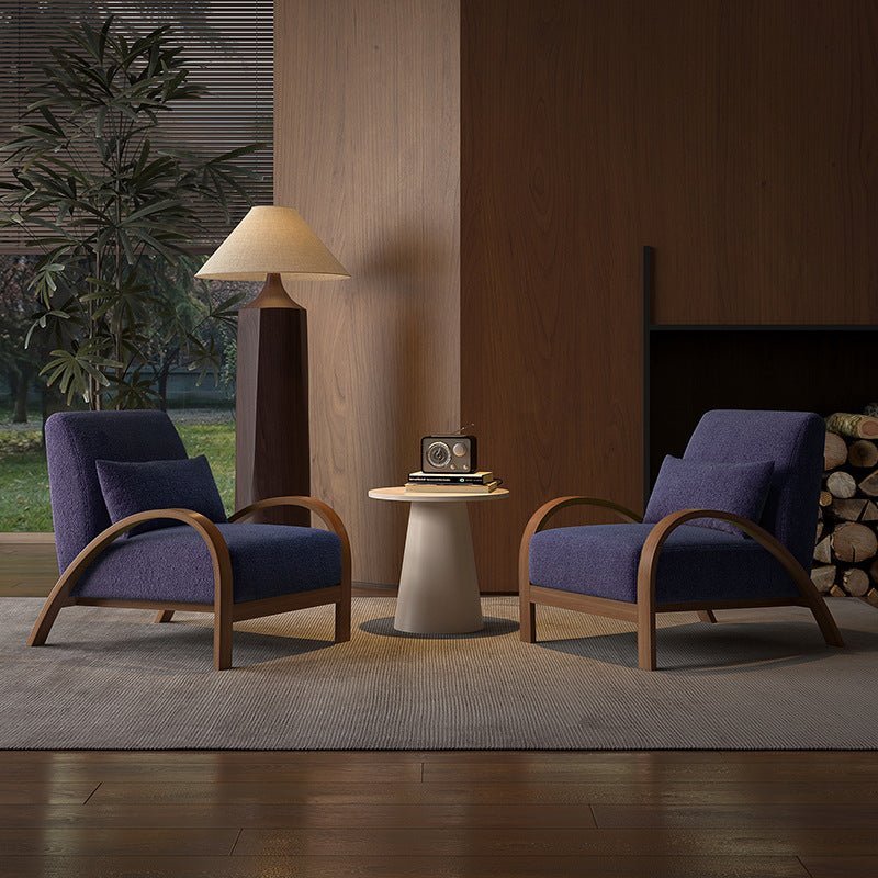 Two modern style armchairs, one with deep blue and brown lines, the other with beige and light brown lines, both with high-quality fabric seats, positioned in a room with a large window and a plant in the background.