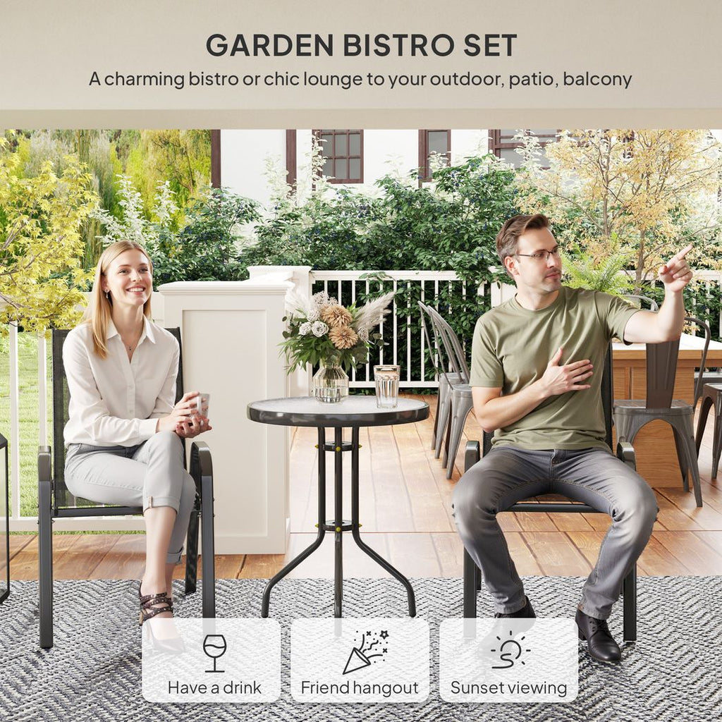 Garden bistro set with two people sitting on chairs and a table outdoors.