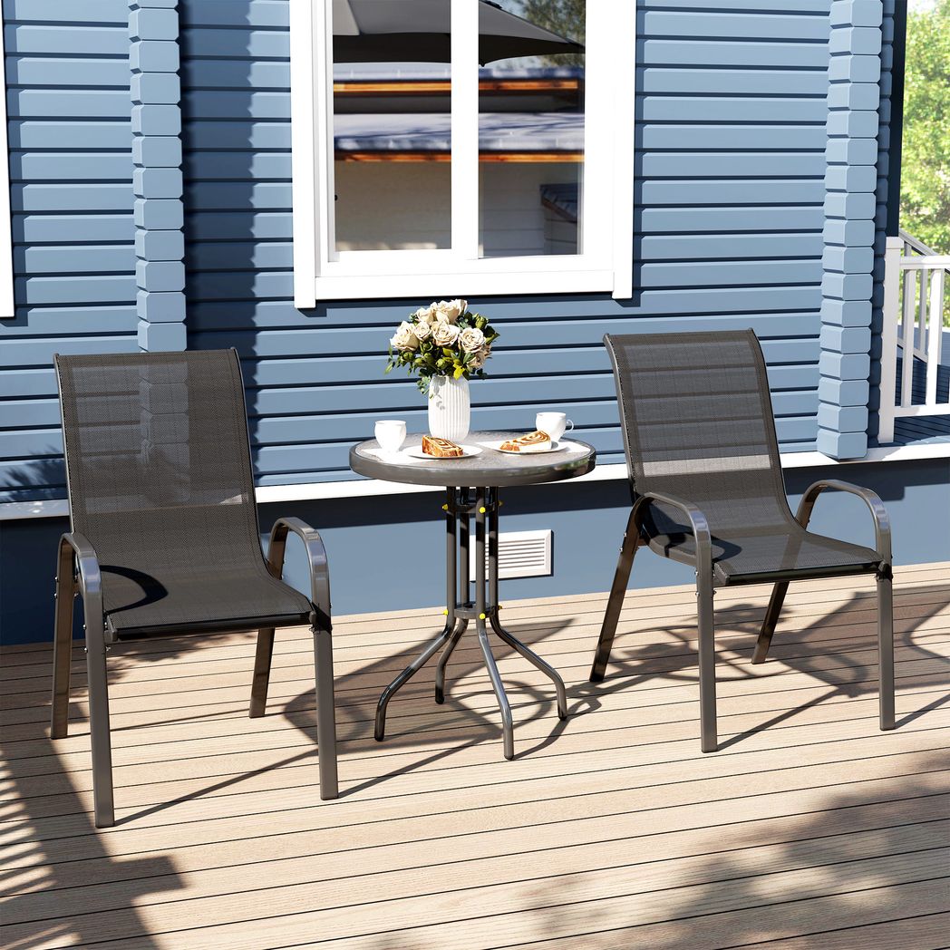 Outdoor patio set with two chairs and a small table on a wooden deck in front of a blue house.