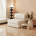 Modern living room with a white sofa, side table, and decorative items.